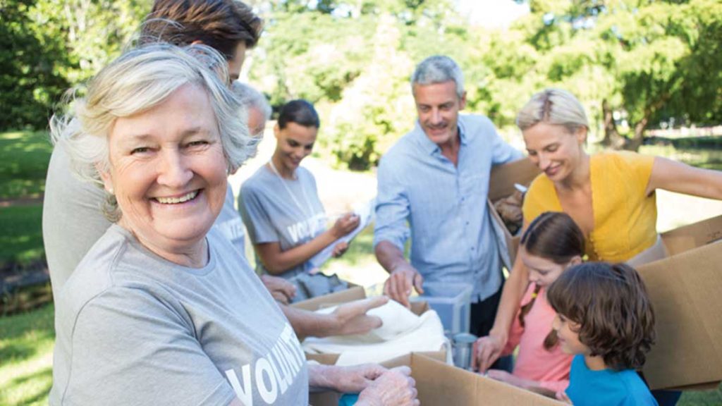 Older female volunteer smiling at camera
