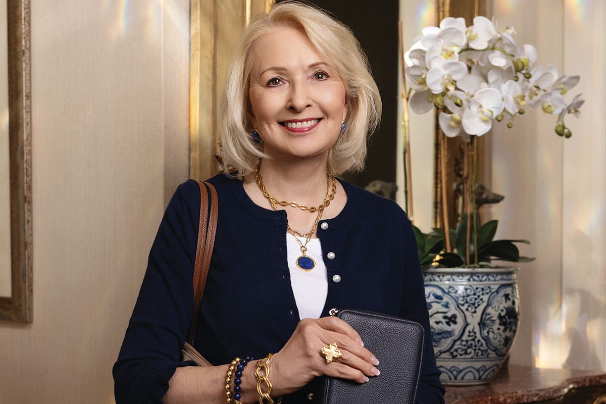 Susan Shaw next to white flowers