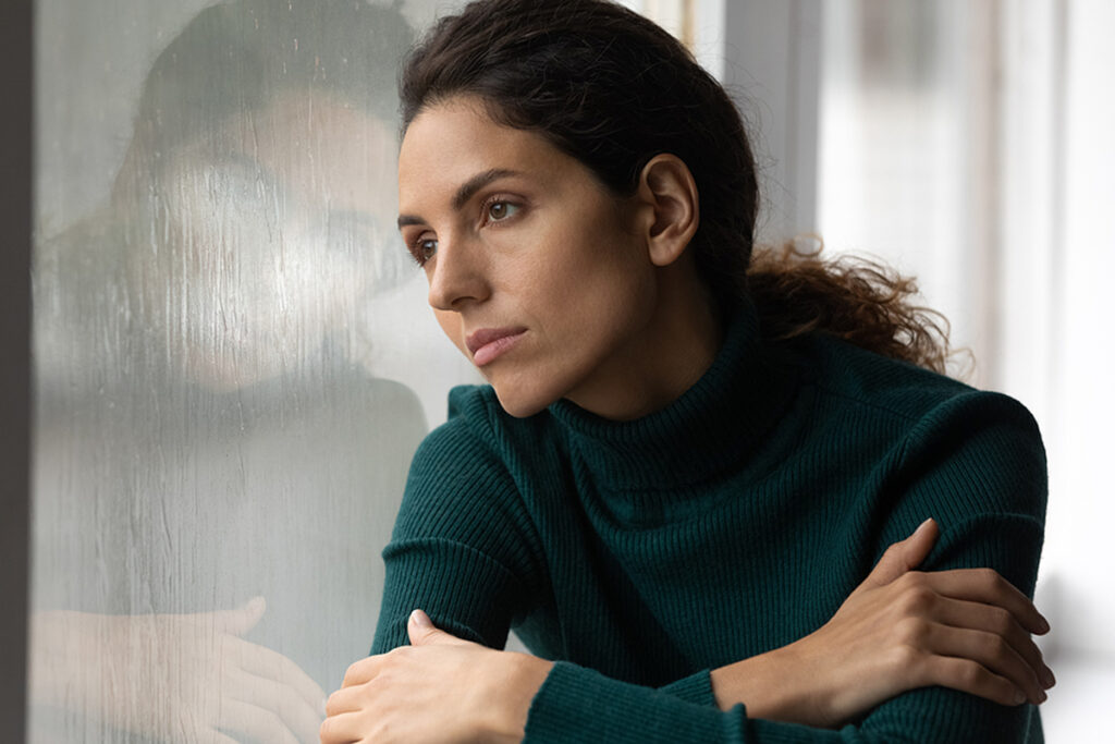 Close Up Thoughtful Upset Woman Looking In Rainy Window Alone
